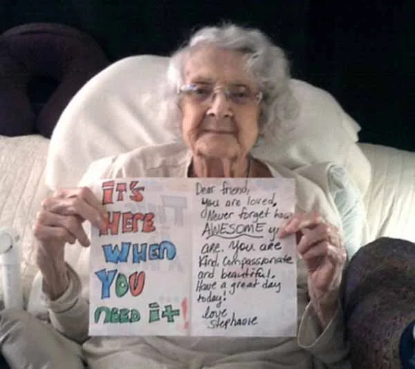 Kindness Ideas For Adults 9 An Elderly Lady Holding A Hand-Made Card.